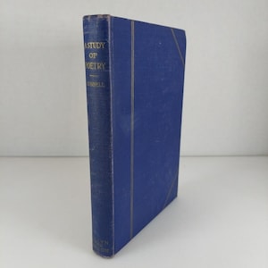 May include: A blue hardcover book titled "A Study of Poetry" with gold lettering. The book's spine displays the title and author's name. The book has a textured cover and a vertical orientation.