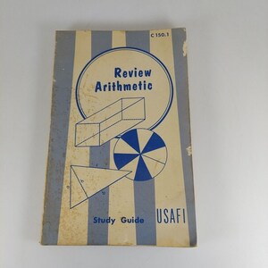 May include: A blue and white striped cover of a book titled "Review Arithmetic" with the text "Study Guide USAFI" and the number "C 150.1". The cover features geometric shapes including a rectangle, a circle, and a triangle.