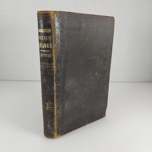 May include: A vintage, dark brown leather-bound book titled "Elementary French Reader" by De Fivas.