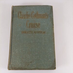 May include: A vintage blue book with gold lettering titled "Charlie Codman's Cruise" by Horatio Alger Jr.
