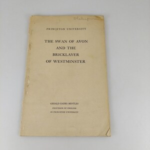 May include: A vintage book cover with the title "The Swan of Avon and the Bricklayer of Westminster" by Gerald Eades Bentley, published by Princeton University. The cover is a faded tan color with the word "Shakespeare" handwritten at the top.