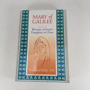 May include: Book cover with a blue and white patterned border. The title is "MARY of GALILEE" with the subtitle "Woman of Israel - Daughter of Zion". The author is Bertrand Buby, SM.