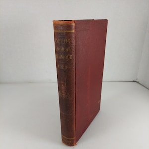 Op de afbeelding: Een rood hardback boek getiteld "Aseptic Surgical Technique" door Robb, uitgegeven door Lea & Febiger.