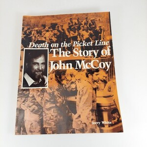May include: A book cover with a brown background and a photo of a group of men in military uniforms. The title is "Death on the Picket Line: The Story of John McCoy" by Jerry White.