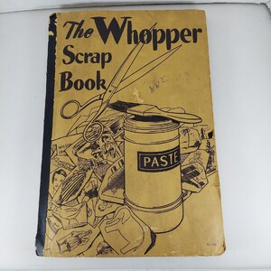 May include: The cover of a vintage scrapbook titled "The Whopper Scrap Book" with a drawing of scissors, a jar of paste, and various other craft supplies.