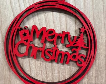 May include: Red wooden Christmas ornament with the words "Merry Christmas" cut out in the center. The ornament has a rustic twine hanger.