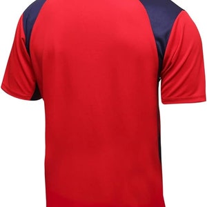 May include: Red and navy blue short-sleeved athletic shirt. The shirt has a navy blue color block on the shoulders and sleeves.