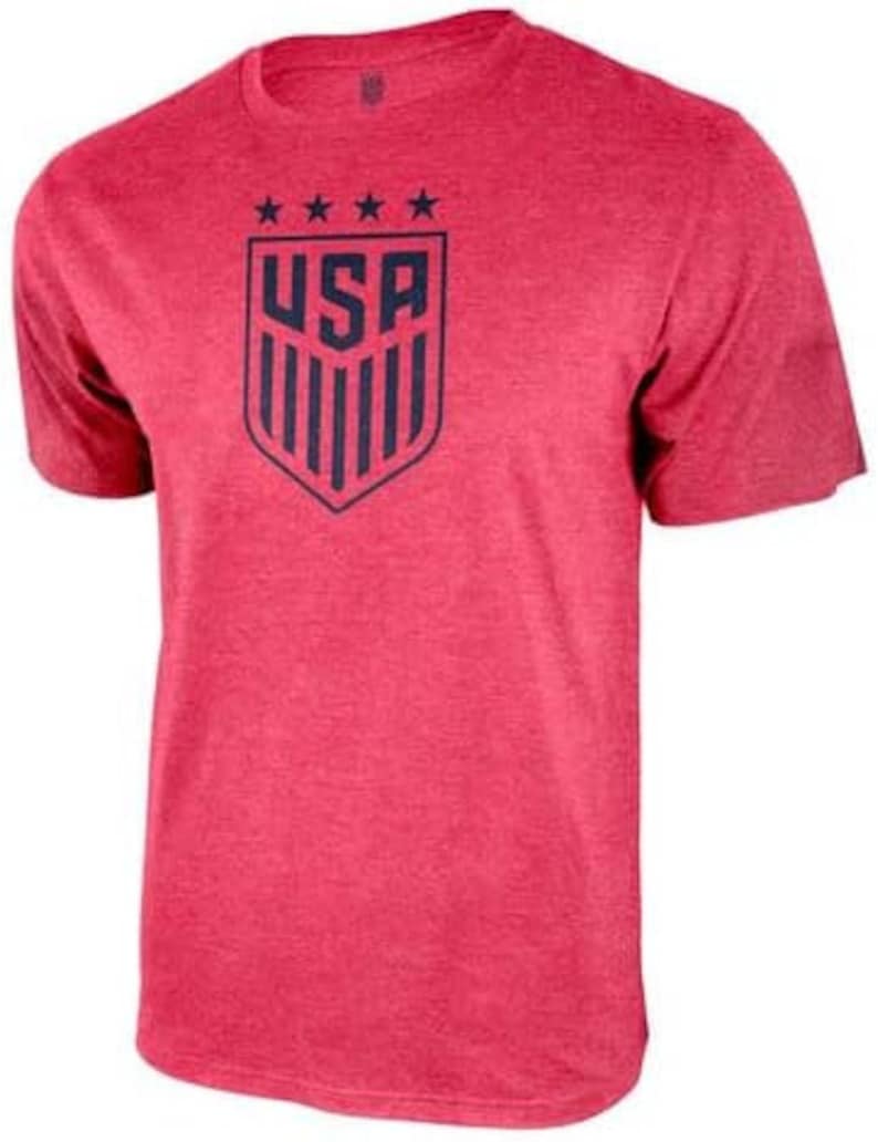 May include: Red short-sleeved t-shirt with a blue and white USA crest graphic. The crest features five stars above the word "USA" and vertical stripes.