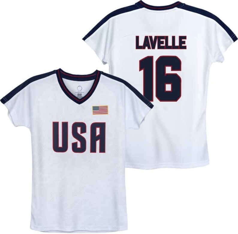 May include: White t-shirt with a navy blue trim and the words "USA" and a small American flag on the front. The back of the shirt has the name "Lavelle" and the number "16" in navy blue.