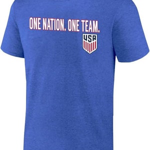 May include: A royal blue t-shirt with the text "ONE NATION. ONE TEAM." and a small USA shield logo on the front.