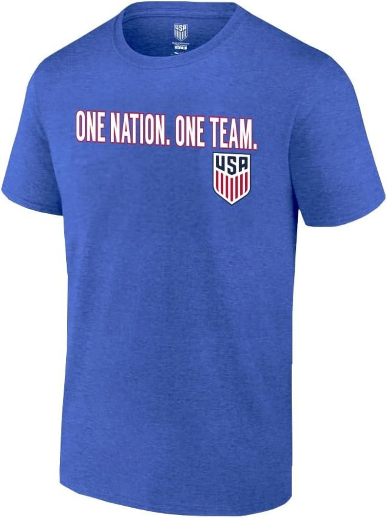 May include: A royal blue t-shirt with the text "ONE NATION. ONE TEAM." and a small USA shield logo on the front.