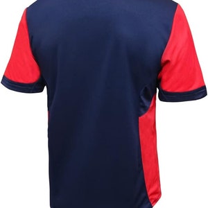 May include: A navy blue short-sleeved jersey with red side panels. The jersey has a crew neck and a plain design.