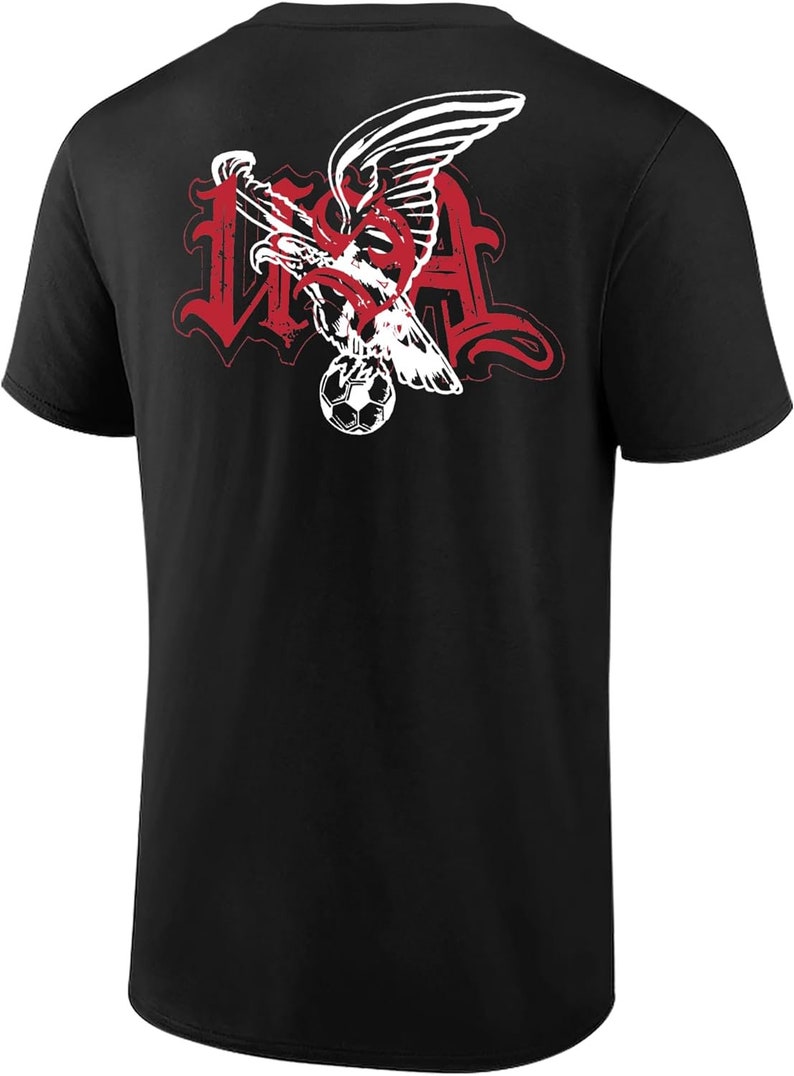 May include: Black t-shirt with a red and white graphic of an eagle holding a soccer ball with the word "USA" in a stylized font.