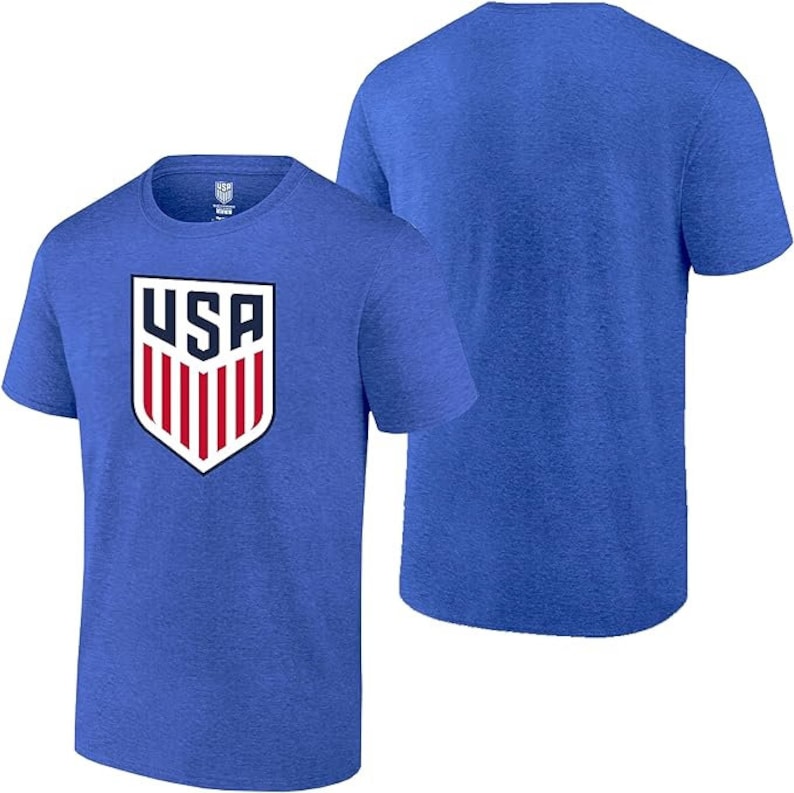 May include: A blue t-shirt with a white and red USA crest on the front. The shirt is made of a soft, comfortable material and has a heather-like texture.
