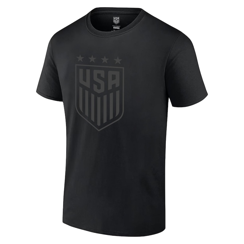 May include: Black t-shirt with a black and white USA crest graphic on the front. The crest features five stars above the word "USA" and a shield with vertical stripes.