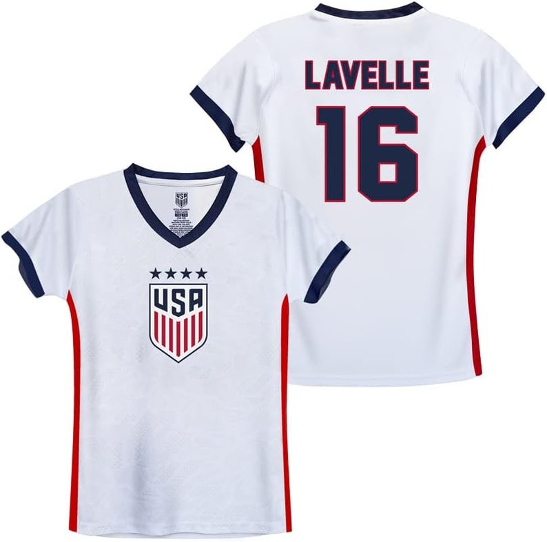 May include: White soccer jersey with red and navy blue trim. The front of the jersey has a USA logo with stars and stripes. The back of the jersey has the name "Lavelle" and the number "16" in navy blue.
