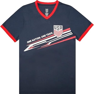 May include: A navy blue t-shirt with red and white accents. The shirt features a graphic of a shield with the word "USA" and the text "One Nation. One Team."