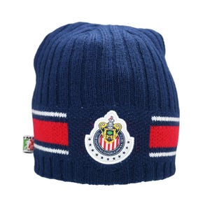 May include: A blue knitted beanie with a red and white stripe pattern. The beanie features a white embroidered logo with the text "Club Deportivo Guadalajara S.A." and a crest.
