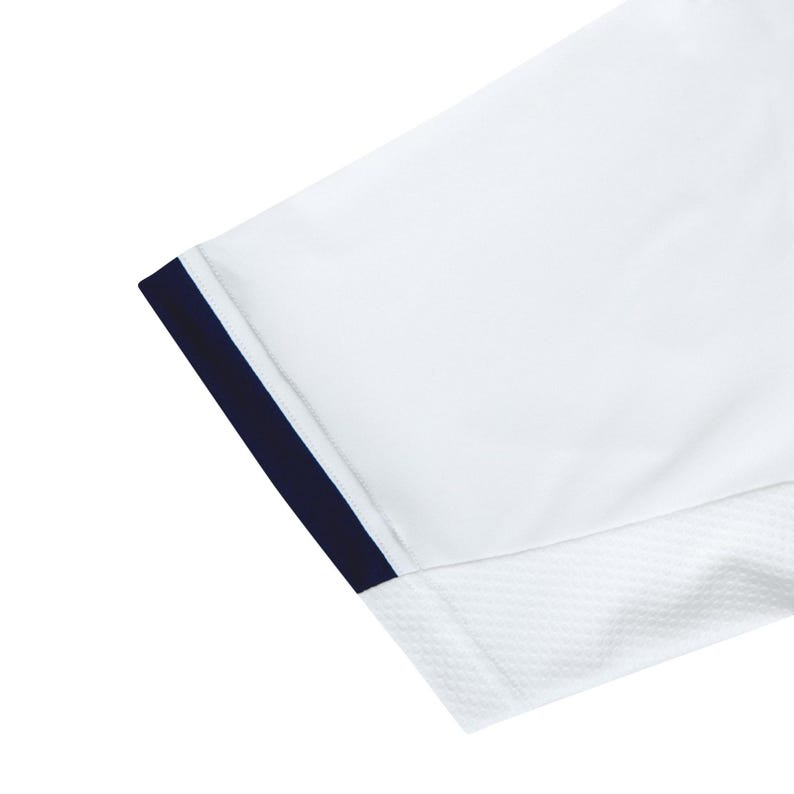 May include: White short-sleeved shirt with a navy blue trim around the sleeve opening. The shirt has a mesh panel on the side.