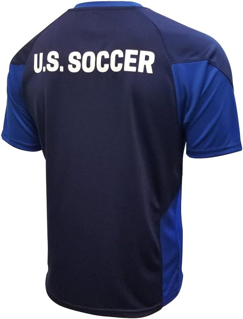 May include: A navy blue soccer jersey with royal blue accents on the sleeves and sides. The back of the jersey has "U.S. SOCCER" printed in white.