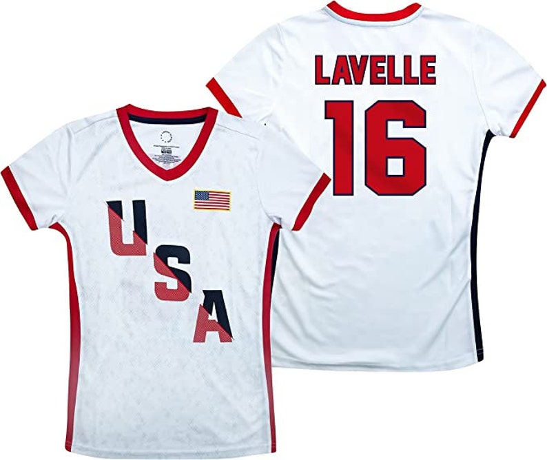 May include: White jersey with red and blue trim. The jersey has the word "USA" in red, white, and blue letters on the front and a small American flag. The back of the jersey has the name "Lavelle" and the number "16" in red.