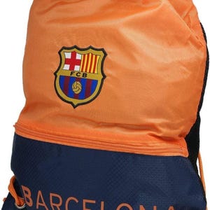 May include: Orange and navy blue drawstring backpack featuring the Barcelona team logo. The bag has a zippered pocket and the word "BARCELONA" printed in orange. The bag is made of a durable material and has a drawstring closure.