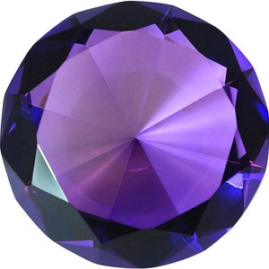 May include: A large, faceted, purple crystal paperweight in the shape of a diamond.