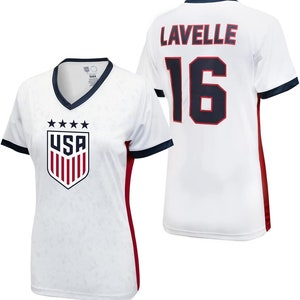May include: White soccer jersey with red and navy blue trim. The jersey has the USA crest on the front and the name "Lavelle" and the number "16" on the back.