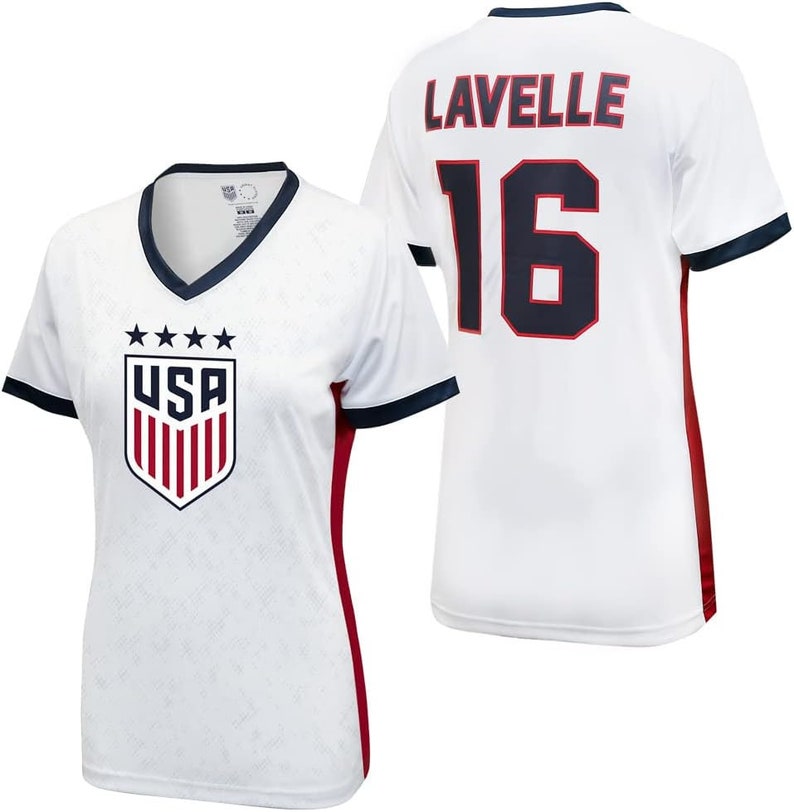May include: White soccer jersey with red and navy blue trim. The jersey has the USA crest on the front and the name "Lavelle" and the number "16" on the back.