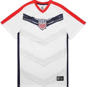 May include: White soccer jersey with red and navy blue accents. The jersey features a stylized USA logo with red, white, and blue stripes. The jersey has a V-neck and short sleeves.