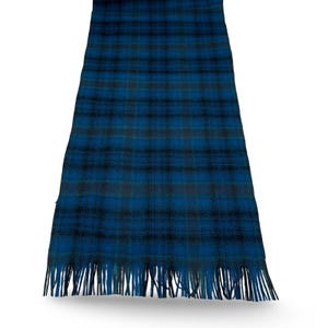 May include: A blue and black plaid scarf with fringe. The scarf features a classic tartan pattern in shades of blue and black, with a fringe along the bottom edge. The scarf is made of a soft material.
