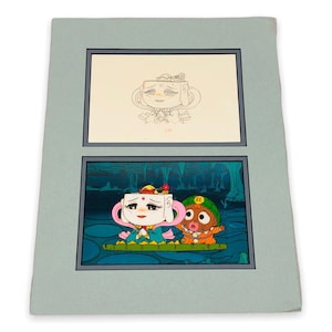 May include: Artwork featuring two panels of cartoon characters. The top panel is a pencil sketch of a character with a teacup-shaped head. The bottom panel shows a color illustration of the same character with a friend, both on a raft.