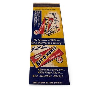 May include: Vintage Bit-O-Honey candy bar matchbook. The matchbook features a red and yellow design with the candy bar name and a 5-cent price. Text includes "Almonds in every bite" and "Six delicious pieces!"