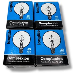 May include: Four boxes of "Complexion" brand light bulbs. Each box is blue with white text and a graphic of a light bulb. The boxes read "longlife", "40 Watt Clear", and "Candelabra Base G-16 1/2".