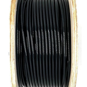 May include: A spool of black cord wrapped around a wooden spool.