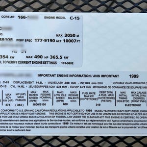 May include: A white sticker with black text detailing engine specifications. The sticker includes information such as engine model, serial number, and performance specs. The text is in English and includes measurements in feet and horsepower.