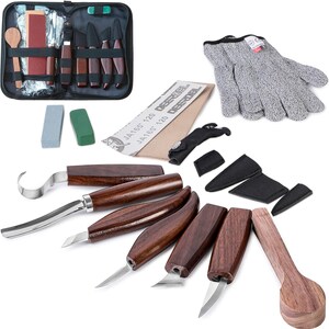 May include: A wood carving set with various knives, a spoon, sharpening stones, sandpaper, and protective gloves. The knives have wooden handles and stainless steel blades. The set includes a zippered carrying case for storage and transport.