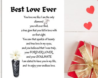 May include: A white card with the text "Best Love Ever" and a romantic poem. A small vase with white flowers is on the left, and a red gift box with a gold bow is on the right. Red heart-shaped decorations are scattered around.