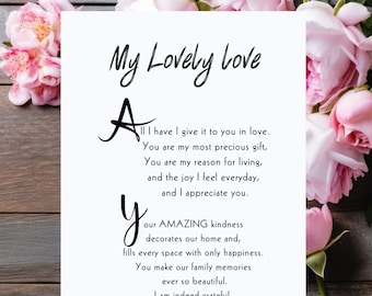 May include: A white card with pink flowers around the edges. The card has a handwritten message that reads "My Lovely Love" and a poem that says "All I have I give it to you in love. You are my most precious gift, You are my reason for living, and the joy I feel everyday, and I appreciate you. Your AMAZING kindness decorates our home and, fills every space with only happiness. You make our family memories ever so beautiful. I am indeed grateful. You have my heart forever, You remain my dearest wife, and mother of my children."