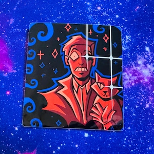 May include: A red and black illustrated sticker featuring a man with a surprised expression and a cat. The man is wearing a red suit and a white shirt. The background is black with blue swirls and white stars.