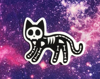 May include: Black and white sticker of a cat skeleton with a galaxy background.