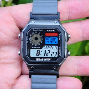 Modified watch based on Casio AE-1200. Color filtered LCD and grey magnetic aftermarket strap