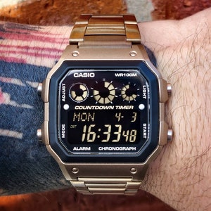 Modified watch based on Casio AE-1300 - bronze color resin case, negative lcd, hydromod, heat treated stainless steel bracelet.