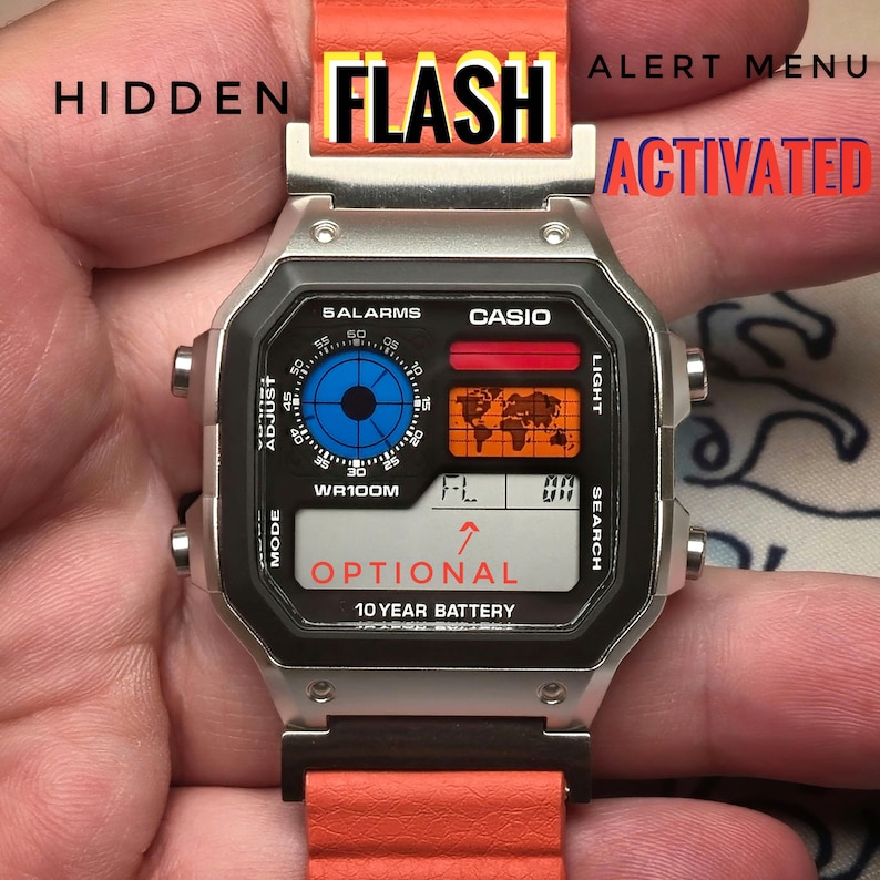 May include: A Casio digital watch with a silver case and an orange band. The watch face displays a world map, a blue dial, and the text "OPTIONAL" and "10 YEAR BATTERY". The word "FLASH" is visible above the watch.