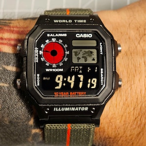 Modified Casio AE-1200 ver2, colorful polarised LCD, hydromod case and army green elastic 22mm strap with red stripe.