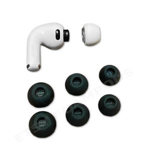 May include: White wireless earbuds with black ear tips, and additional black ear tips. The earbuds are shown disassembled, with one earbud separated from its ear tip. The ear tips are black, and the earbuds are white.