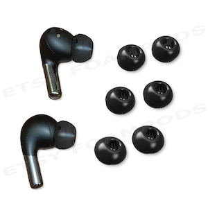 May include: Black wireless earbuds and replacement ear tips. The earbuds have a silver stem and a black earbud. The ear tips are black and come in various sizes. The items are displayed on a white background.