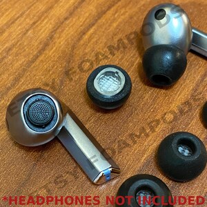 May include: A set of three black earbud tips with a silver earbud housing. The earbud tips have a small hole in the center. The earbud housing has a small microphone on the side. *HEADPHONES NOT INCLUDED*