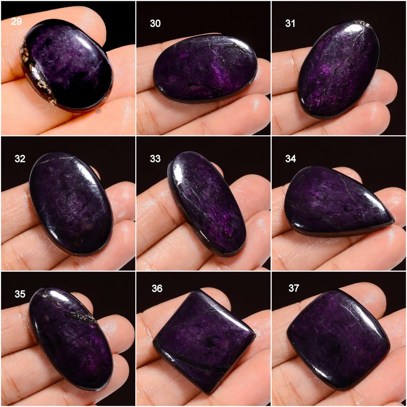 May include: A collection of polished, deep purple charoite gemstones in various shapes, including oval, teardrop, and square. The stones display a swirling, fibrous pattern with hints of lighter purple and black.