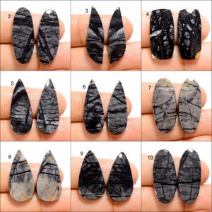 May include: Ten pairs of black and white stone cabochons in various shapes, including oval, teardrop, and pear. The stones have a natural, marbled pattern.